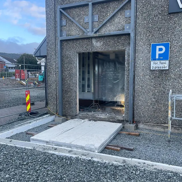 Større døråpning skjært ut i en betongvegg, omkranset av stålramme.